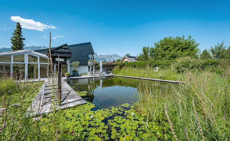 SINGLE-FAMILY HOME WITH AN EXCEPTIONAL GARDEN OASIS AND SWIMMING POND - Photo 2
